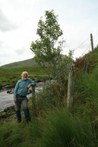 I took this photo of me standing beside the eared willow in July 2008 to show how large the bush had grown since it was protected.