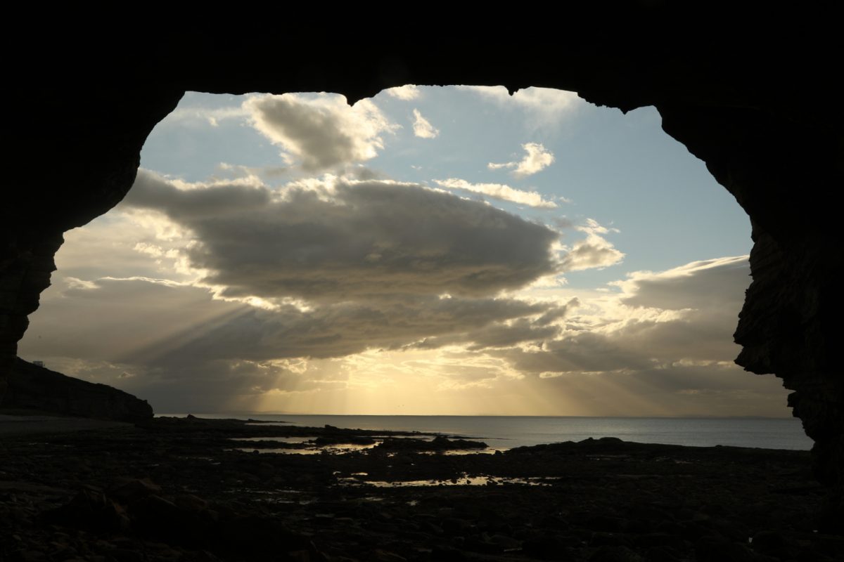 Cave view, sun shafts, Moray Firth, Moray coast, dramatic light