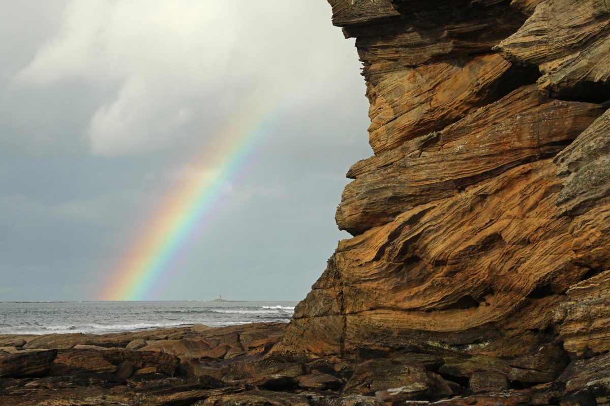 Rainbow, sandstone cliff, Moray coast, Scotland